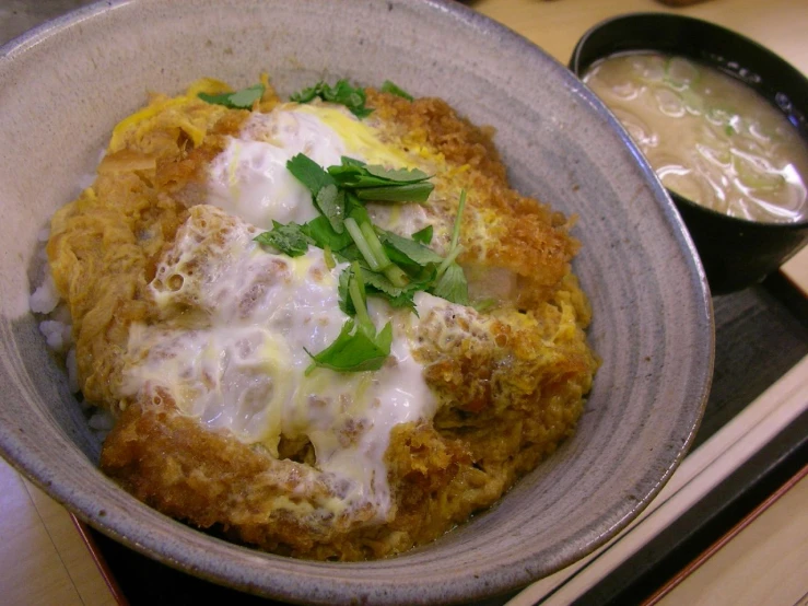 a bowl of food on top of a stove with soup