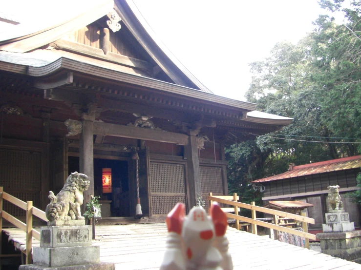 a statue in the foreground and buildings in the background