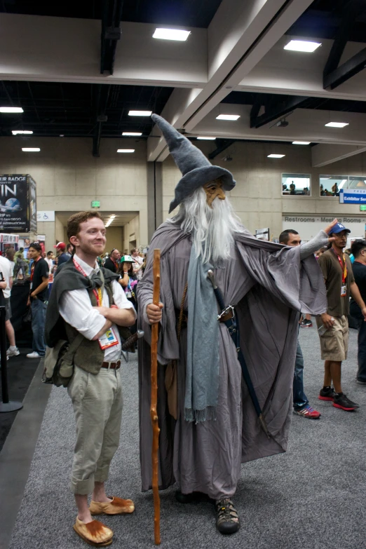 a man dressed in costume standing next to a wizard