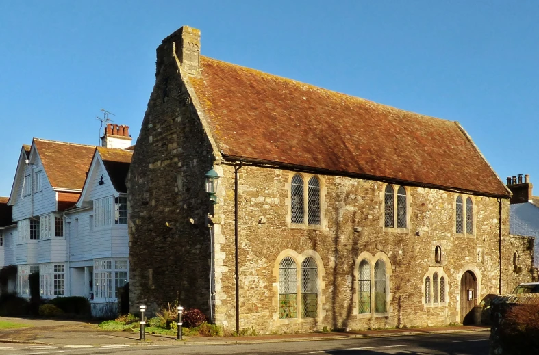 an old church building next to the sidewalk