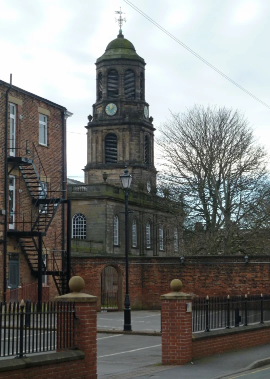 an old building with a clock and steeple on the side