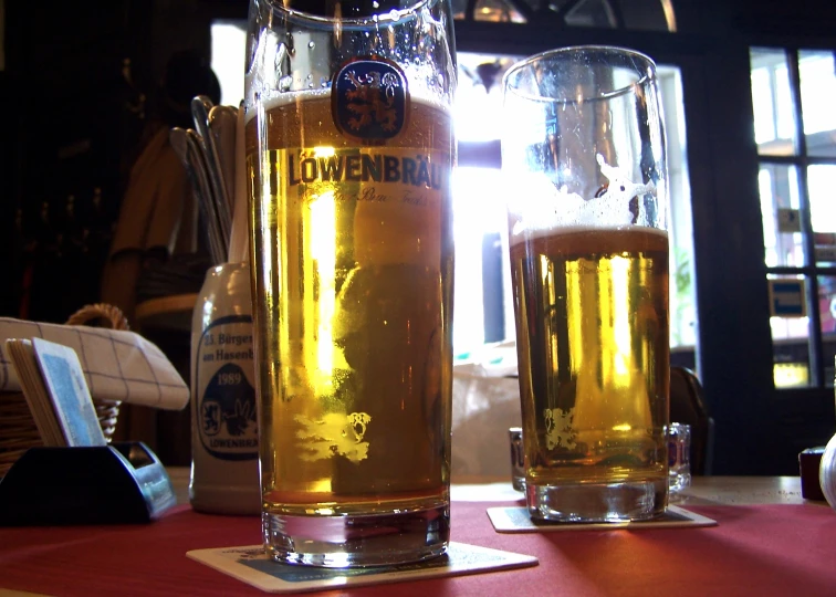 beer in a glass next to another glass