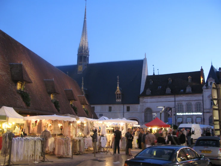 a number of people in front of tents on the ground