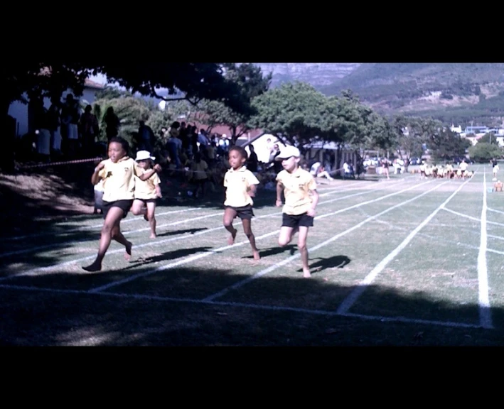 two small children are playing soccer on the field