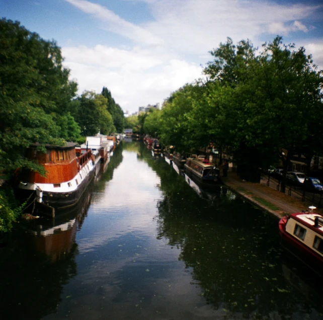 boats are docked on a narrow body of water