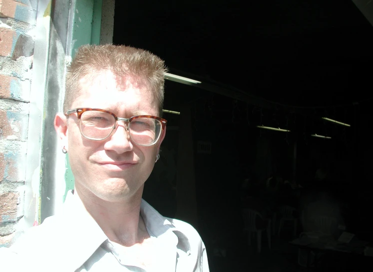a man with glasses wearing a white shirt