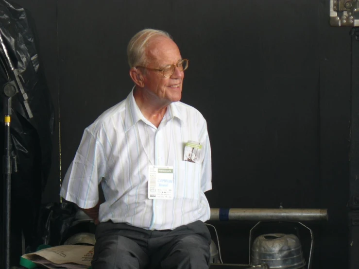 a man sits on the back of a vehicle