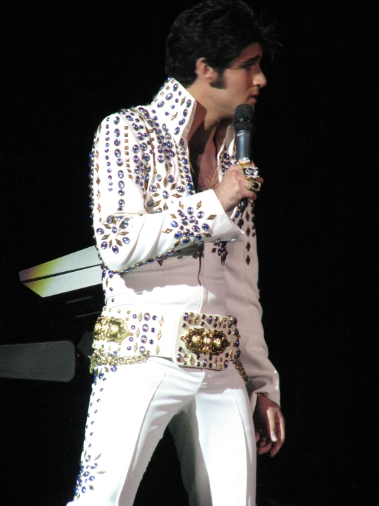 elvis elvis singing with a microphone at night