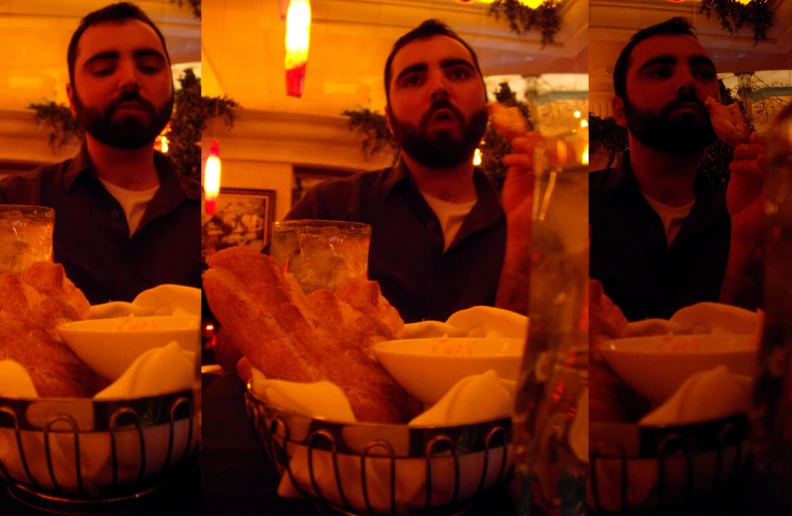 a man holding three cups and eating food