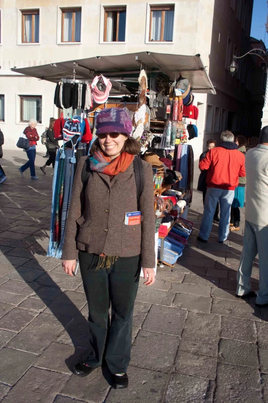 a woman with a hat on is walking near the flea