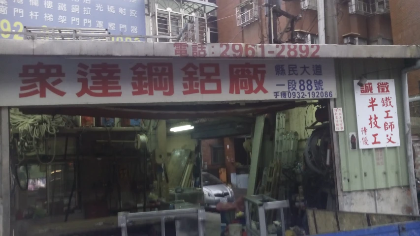 an asian sign above a building with lots of people standing in front