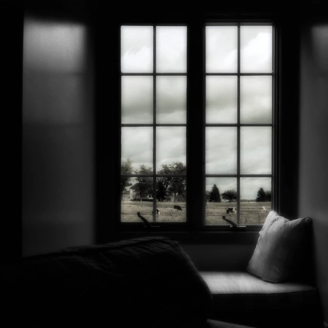 a chair sits in front of a window with an image outside