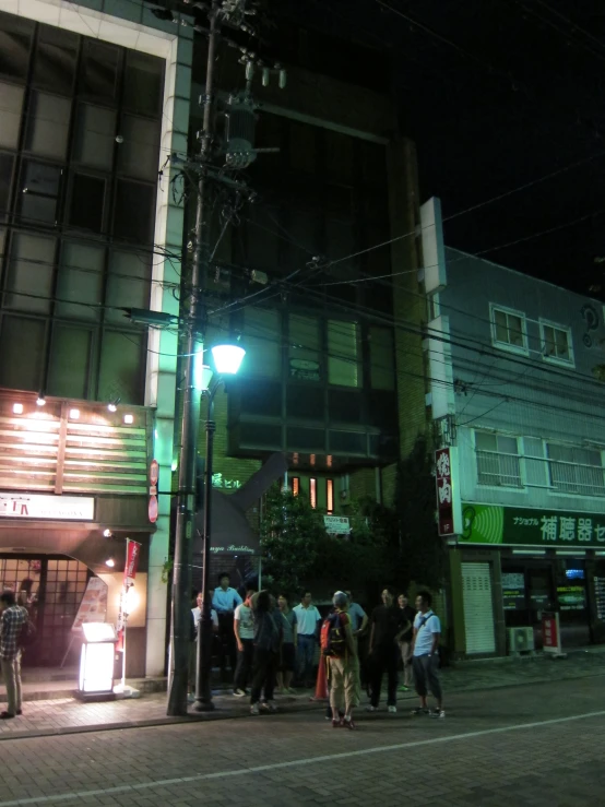 a group of people that are standing outside at night