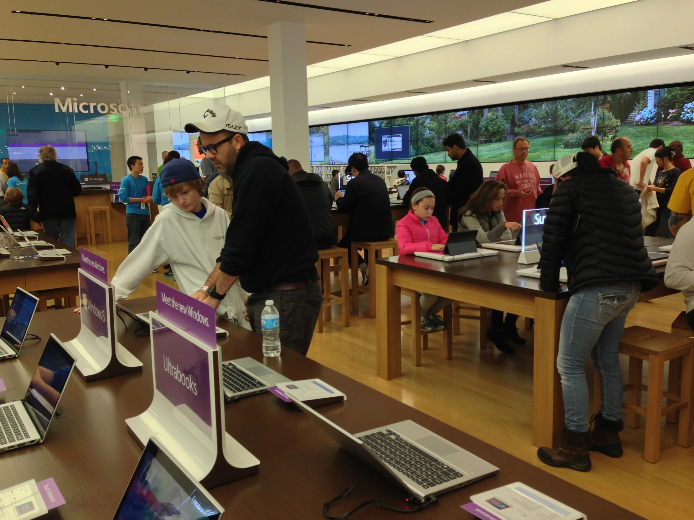 a group of people using laptops in a computer shop