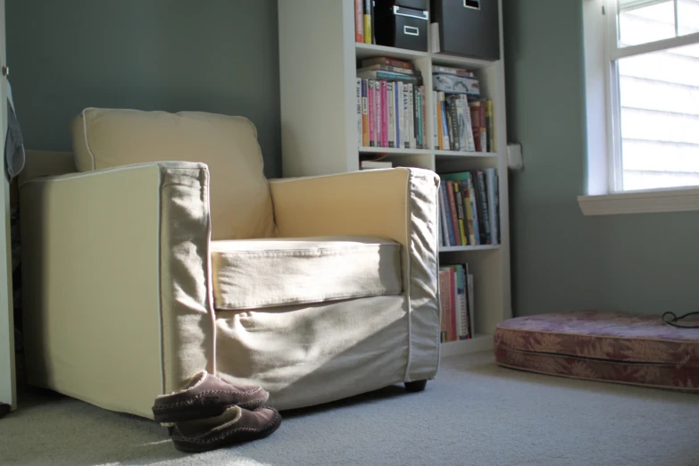 a small room with some bookshelves and a chair in it