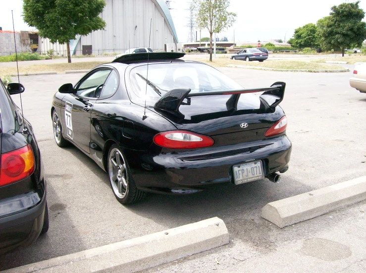 the back of a black sports car with a license plate