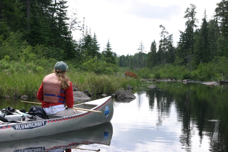 a man in a canoe on the river