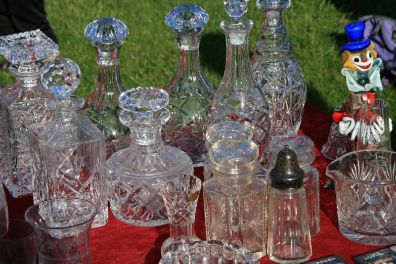 a table with many old glass vases and candles