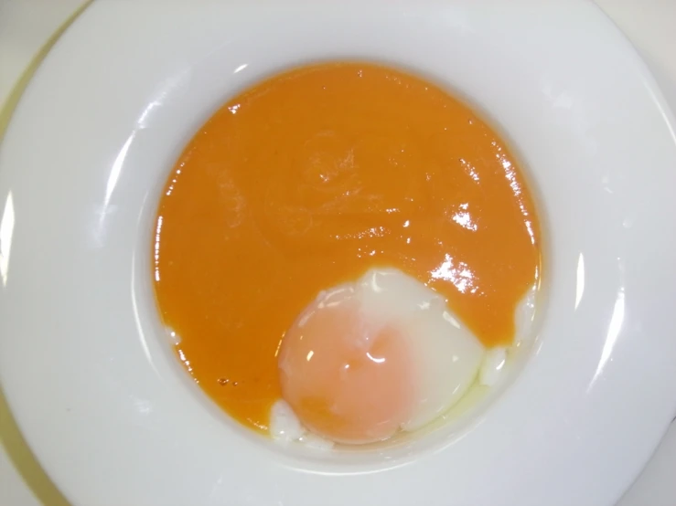 an egg on a plate with yolk in the center