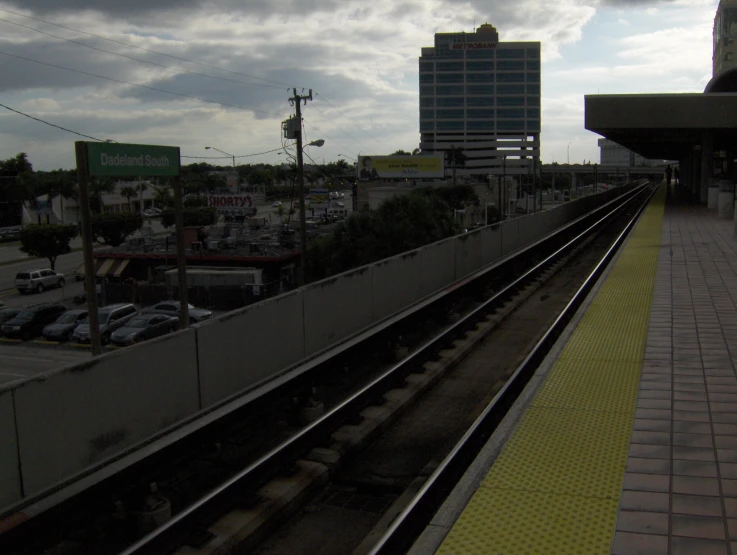 a train platform sitting in front of a city with tall buildings