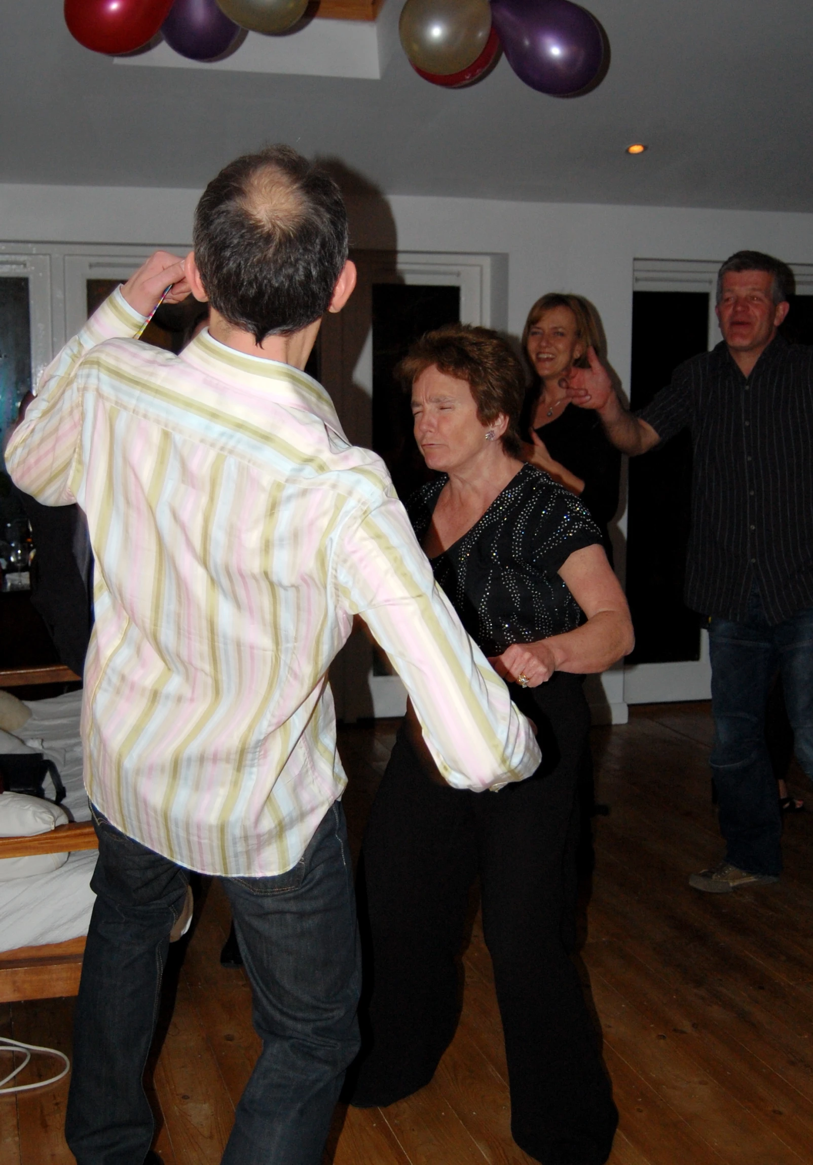 a man is dancing with people at a party