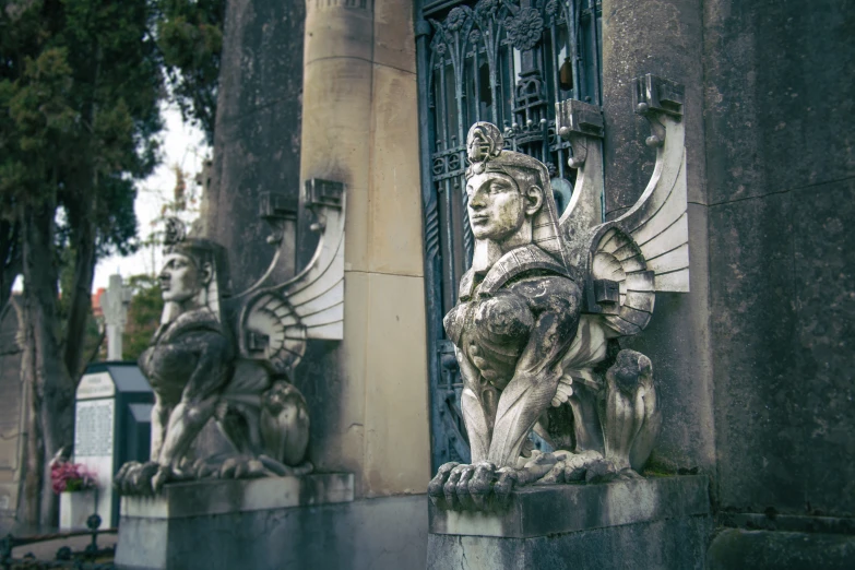 statues of lions on top of two buildings