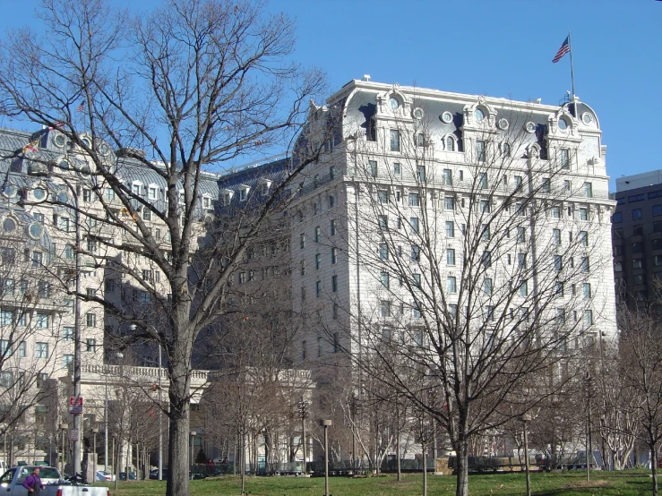 large buildings in a city park with grass