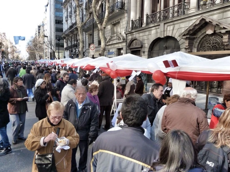 several people walking in a busy city market