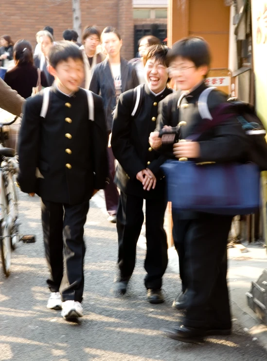 boys are marching down the road together on bicycles