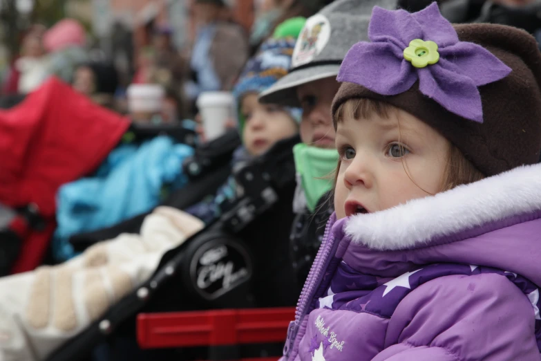 the child is wearing a hat with flower in it