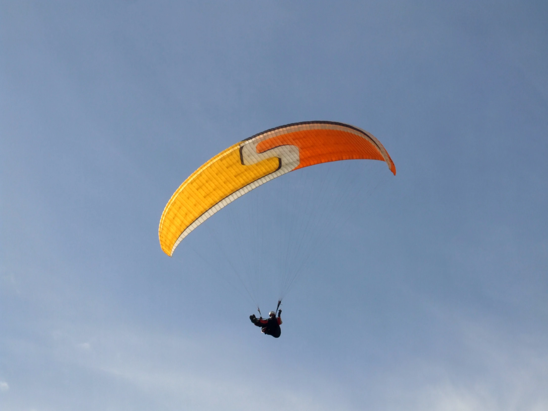 a person is paragliding through the sky