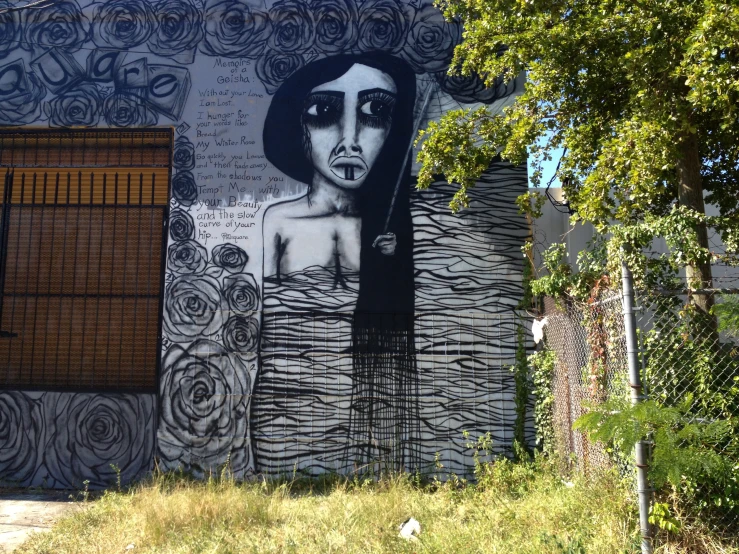 mural of woman on wall in urban setting