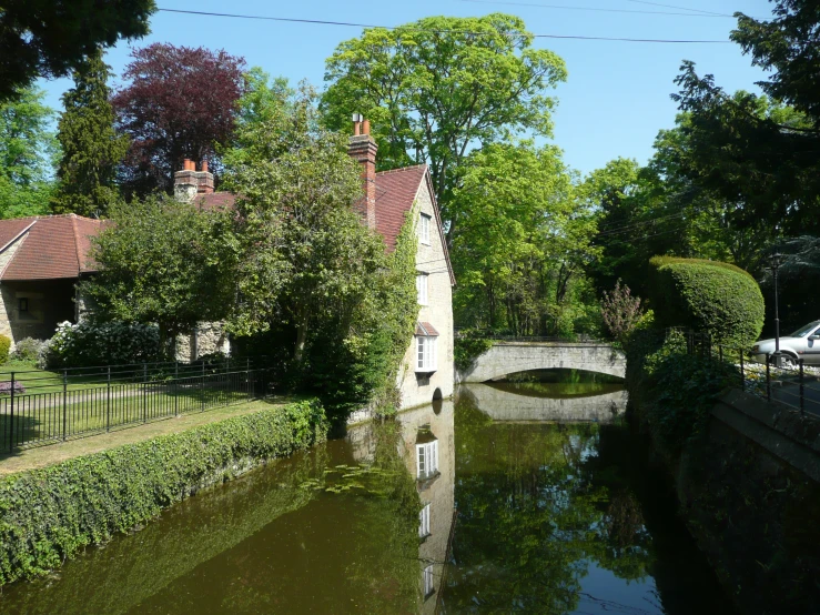 a river is surrounded by a fence and tree's