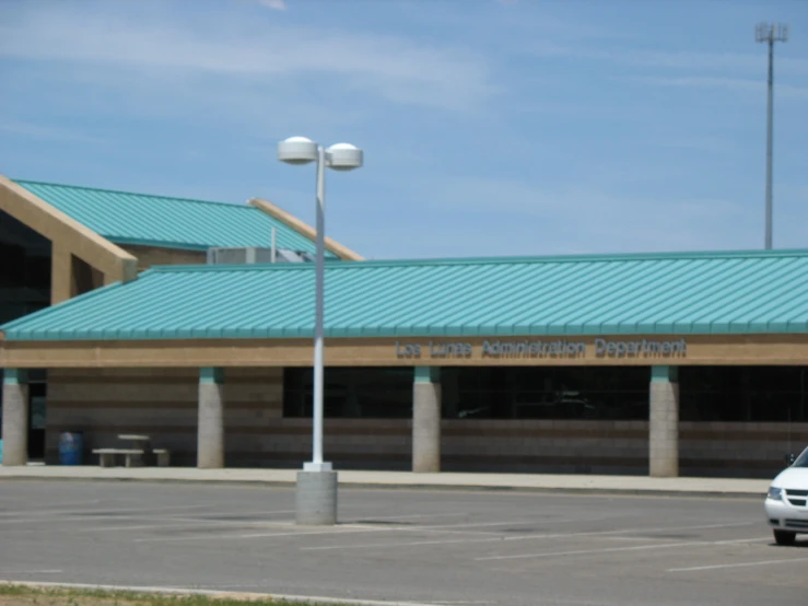 a car parked outside of a large airport building