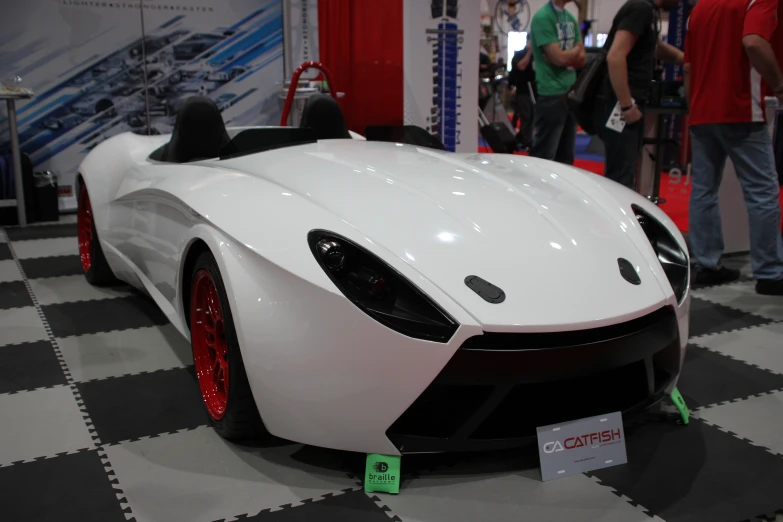 an all white sports car on display at the show