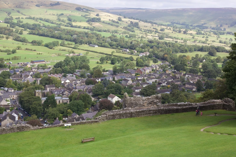 a village and its surrounding countryside on the top of a hill