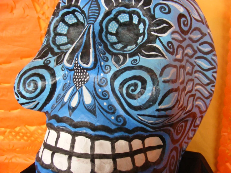 a blue skull is shown on a yellow background