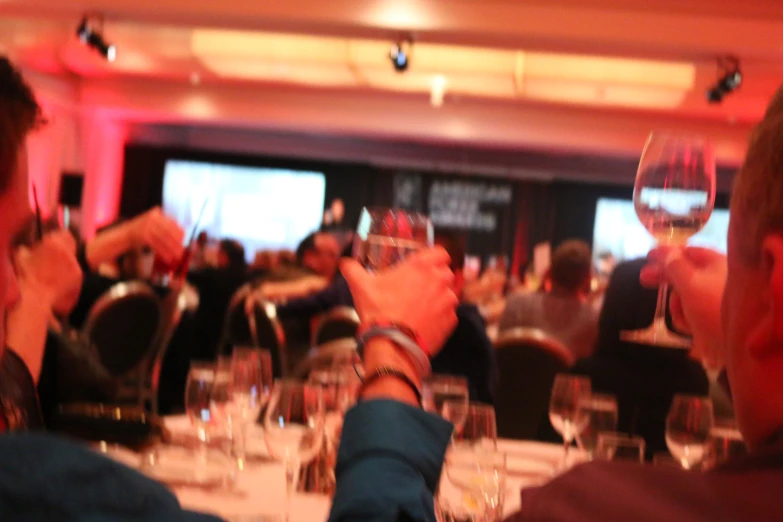 a couple is drinking wine at a formal function