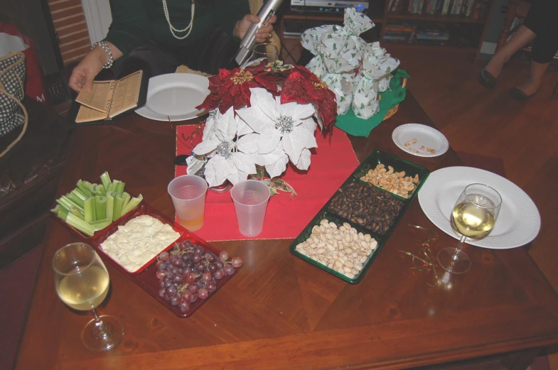 a table full of food and wine glasses with wine on it