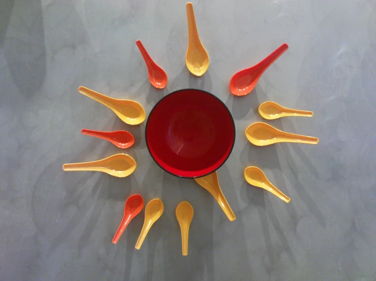 the spoons and cups in the sun are painted red