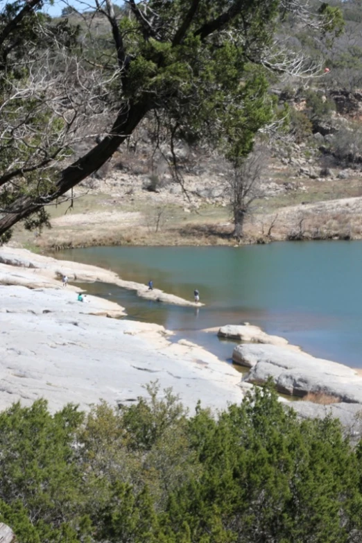 several people in shallow water on a very nice day