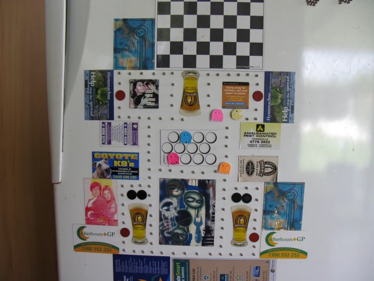 many stickers and decals are embedded into the side of the refrigerator