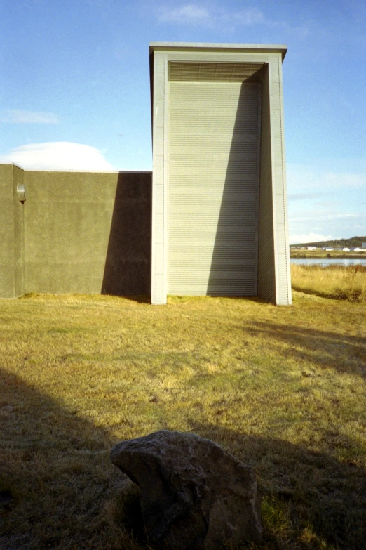 a large yellow building in the middle of a field