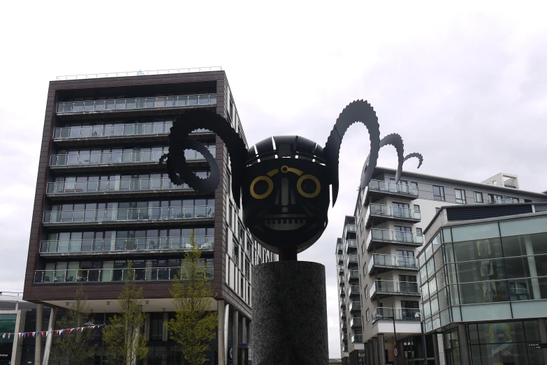 a black statue with gold eyes and a spider figure