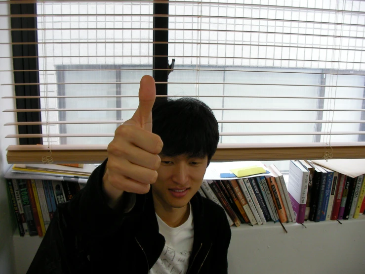a person pointing up with an index finger