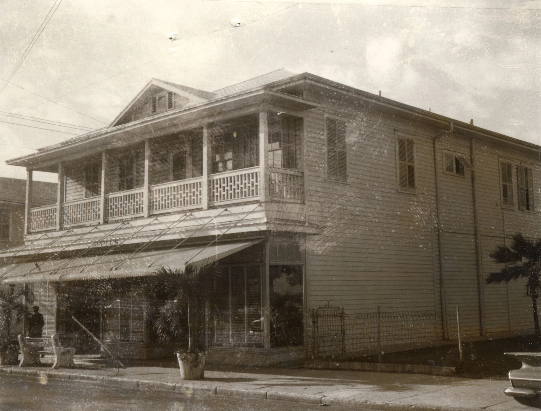 an old house with a balcony and railing