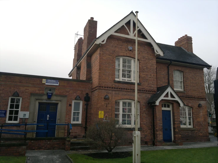 an old brick building with a blue door and windows