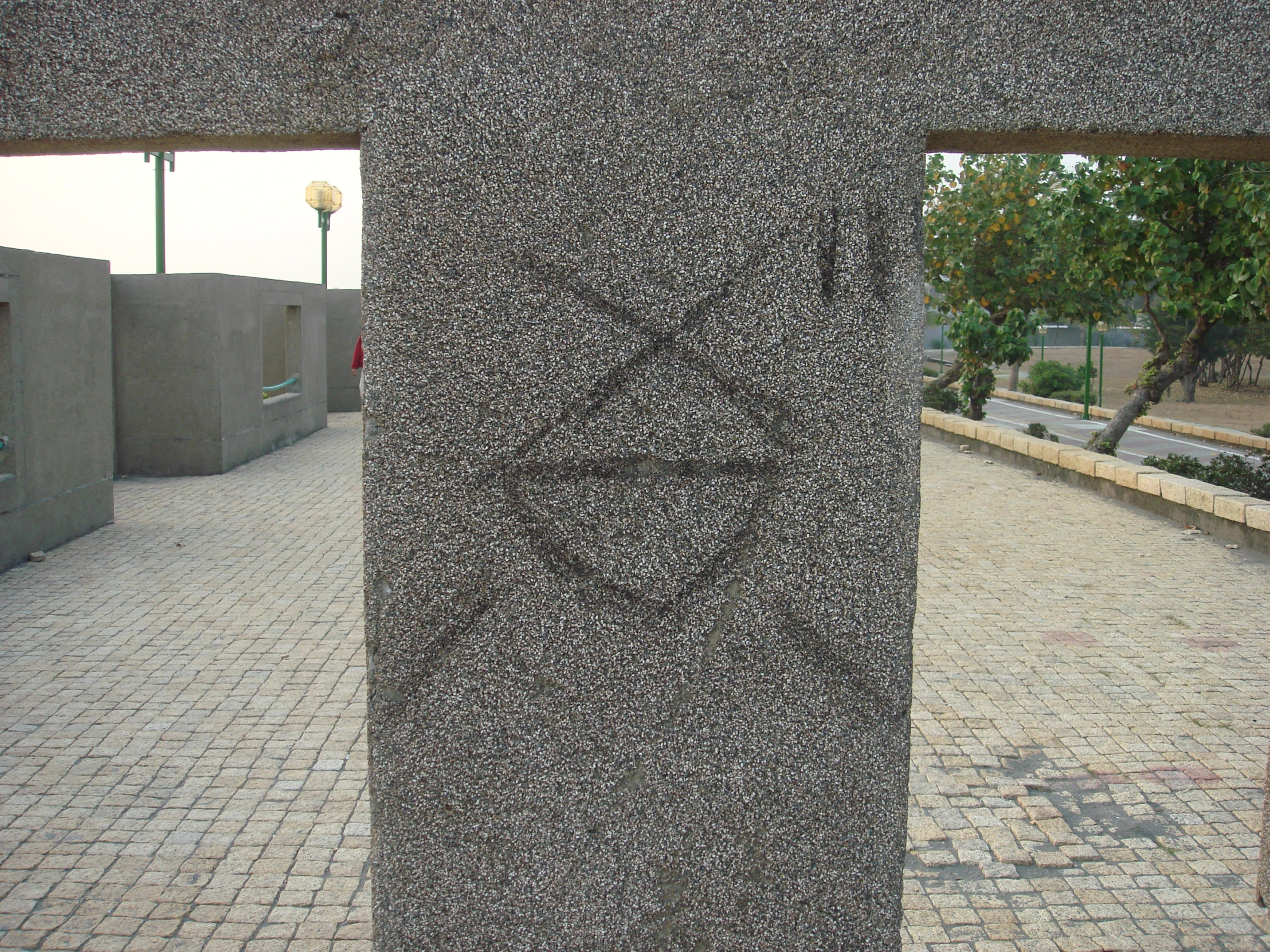 a sculpture with a heart on it and a tree in the background