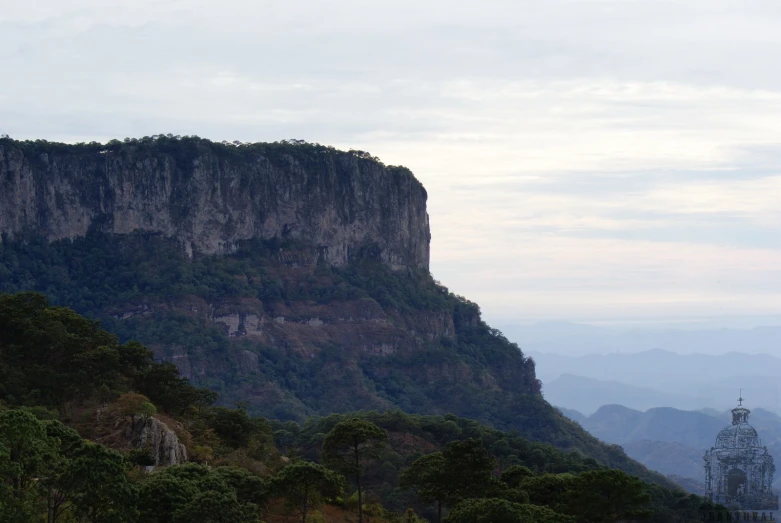 mountain with lots of tree and cliff side near it