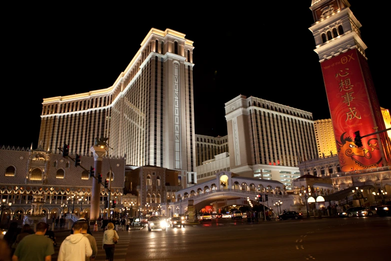 many people in the foreground and very large buildings